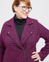 Woman wearing a purple coat with a plain background. This biker jacket is the Canton Moto Jacket sewing pattern from Cashmerette.