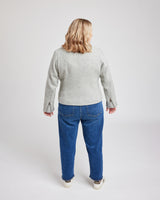 Person wearing a gray jacket and blue jeans on a white background. This biker jacket is the Canton Moto Jacket sewing pattern from Cashmerette.