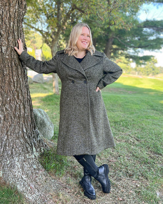 Woman in a long coat standing next to a tree in a park. This coat is the Savin Coat sewing pattern from Cashmerette.