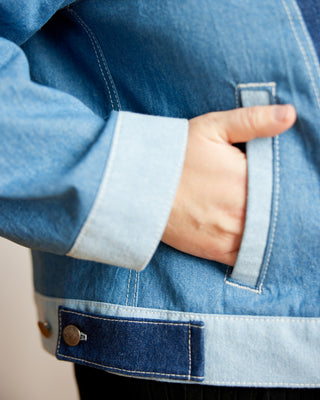 Close-up of a person wearing a blue denim jacket with a hand in the pocket. This jacket is the Glover Jean Jacket sewing pattern from Cashmerette.