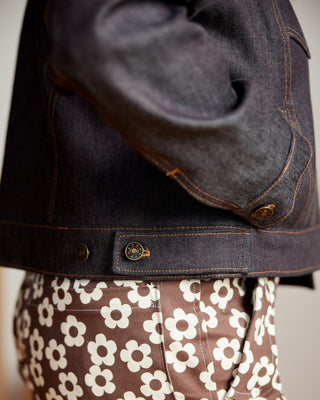 Dark denim jacket with floral-patterned pants. This jacket is the Glover Jean Jacket sewing pattern from Cashmerette.