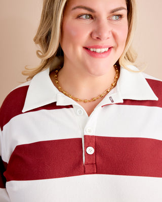 Woman wearing a red and white striped shirt with a beige background. This is the Brookhaven Sweatshirt sewing pattern from Cashmerette.