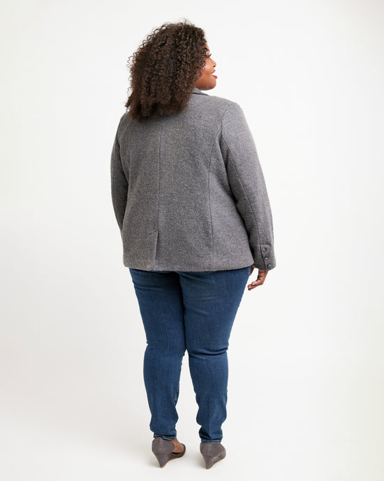 Person wearing a gray blazer and blue jeans on a white background. This blazer is the Auburn Blazer sewing pattern from Cashmerette.
