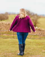 Person wearing a purple coat and blue jeans standing in a field. This blazer is the Auburn Blazer sewing pattern from Cashmerette.