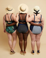 Three women wearing swimsuits with different patterns on a beige background. This swimsuit is the Ipswich Swimsuit sewing pattern from Cashmerette.