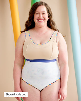 Woman wearing a swimsuit inside out. This is the Truro Swimsuit sewing pattern from Cashmerette. In the bottom left corner in a white box is the text: "shown inside out"
