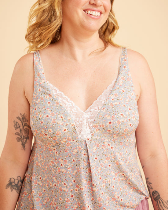 Woman wearing a floral sleeveless top against a beige background. This is the Fiske Sleepwear Set sewing pattern from Cashmerette.