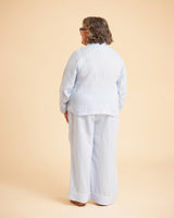 Person wearing a light blue outfit on a beige background. This is the Fiske Sleepwear Set sewing pattern from Cashmerette.