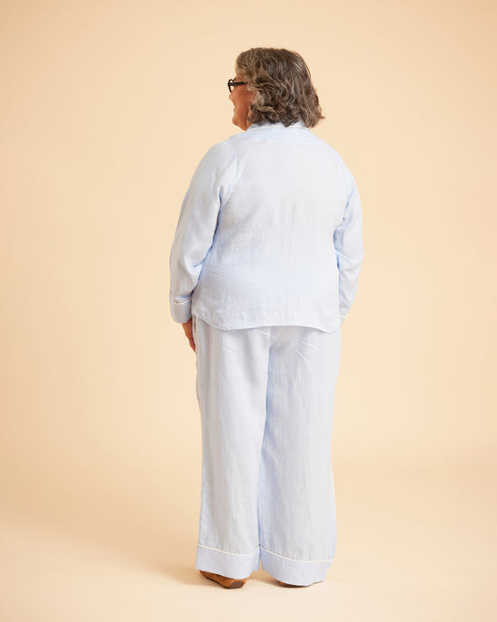 Person wearing a light blue outfit on a beige background. This is the Fiske Sleepwear Set sewing pattern from Cashmerette.