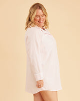 Woman wearing a white nightshirt on a beige background. This is the Fiske Sleepwear Set sewing pattern from Cashmerette.