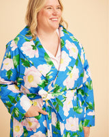 Woman wearing a blue floral robe against a beige background. This is the Fiske Sleepwear Set sewing pattern from Cashmerette.