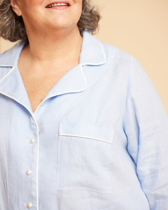 Light blue shirt worn by a person on a beige background. This is the Fiske Sleepwear Set sewing pattern from Cashmerette.