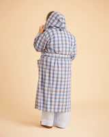Person wearing a blue plaid coat on a beige background. This is the Fiske Sleepwear Set sewing pattern from Cashmerette.