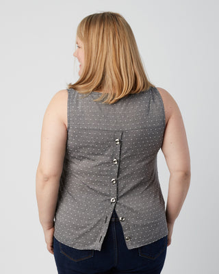 Woman wearing a gray polka dot vest on a plain background. This is a pattern hack of the Springfield Top from the Pattern Hacking for Curves class.
