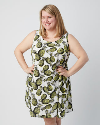Woman wearing a sleeveless dress with pineapple pattern on a plain background. This is a pattern hack of the Springfield Top from the Pattern Hacking for Curves class.