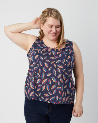 Woman wearing a sleeveless top with feather pattern against a plain background. This is a pattern hack of the Springfield Top from the Pattern Hacking for Curves class.
