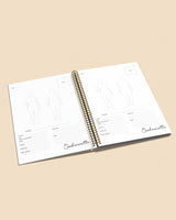 Open planner with spiral binding on a beige background