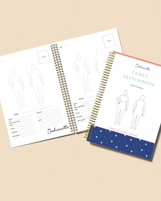Two fashion design sketchbooks with templates on a beige background